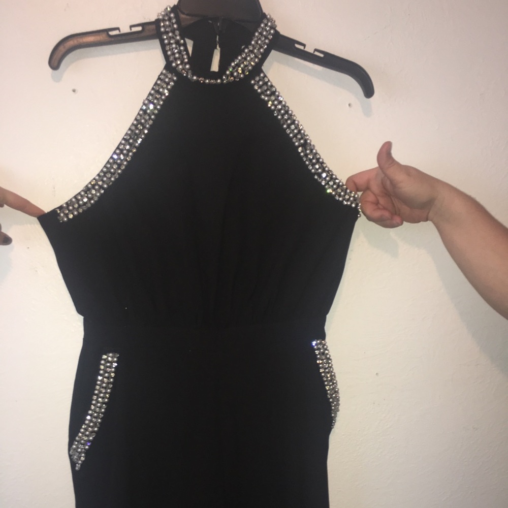 Black jumpsuit with jewel detailing.